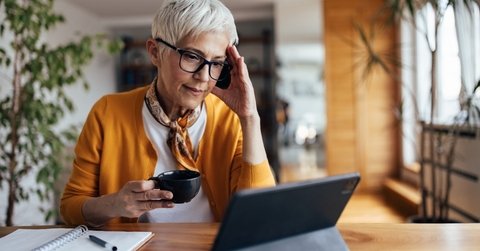senior lady in stress looking at laptop
