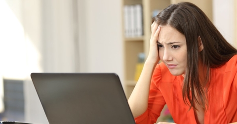 frustrated young woman using a laptop
