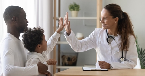 doctor, child, and father during a doctor visit