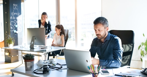 three businesspeople in the office working together