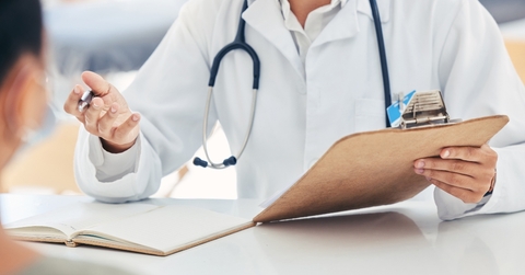 doctor talking about health insurance at clinic