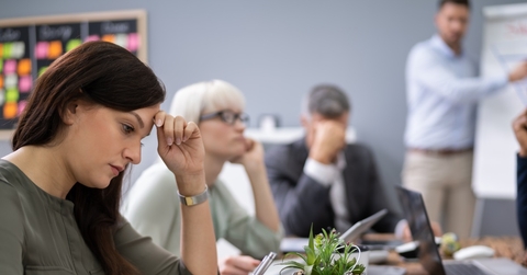 bunch of colleagues sad in presentation room at workplace