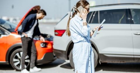 woman calling road assistance after the car collision