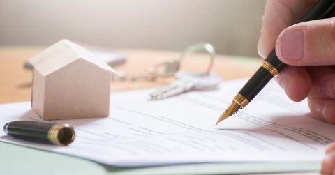 man signing documents with fountain pen