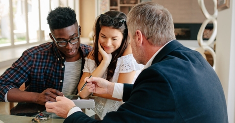 real estate agent explaining agreement to a couple