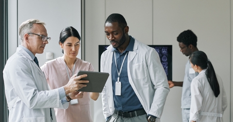 group of doctors looking at digital tablet