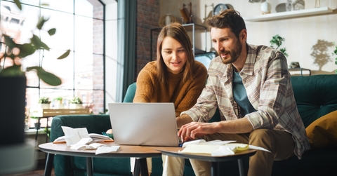 couple doing accounting using laptop