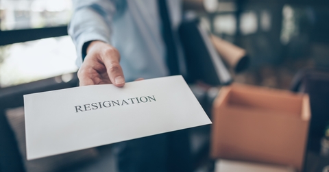businessman showing resignation letter to employer boss