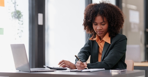 woman working on laptop and doing taxes