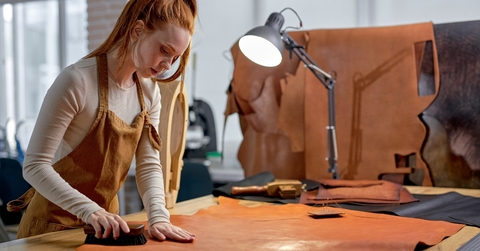 hardworking artisan concentrated on keeping leather in good shape