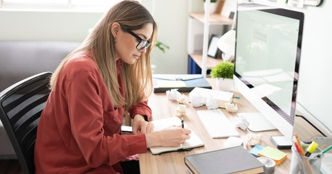 female author sitting in front of computer to write stories