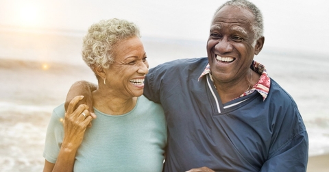 happy african american senior couples trolling at beach