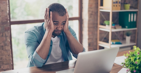 Man frustrated looking at computer