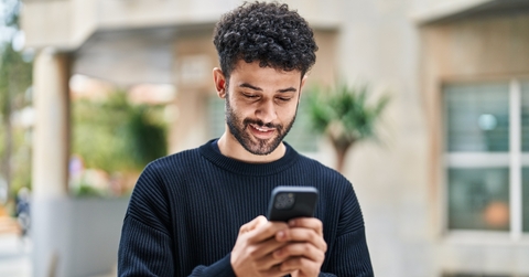 Man looking at phone and smiling
