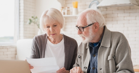 snior laptop sitting at table reviewing loans 