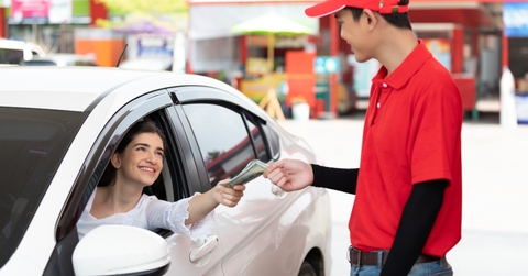 worker receiving money from driver customer