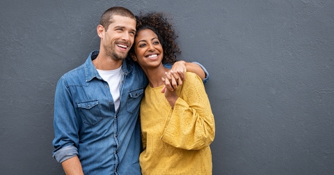 multiethnic couple in love standing and holding hands