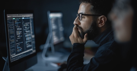 man coding on computer late at night