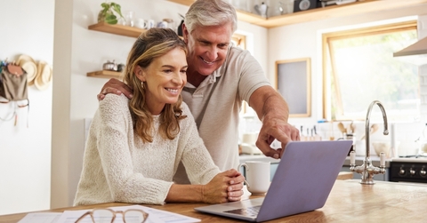 An older couple looking at computer