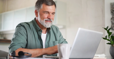 mature man in casual suit sitting at the table 