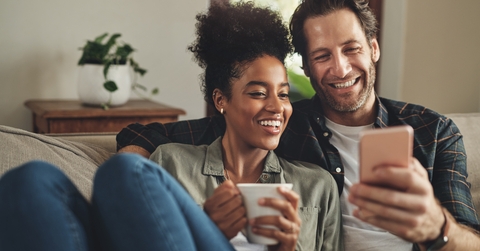 young couple using a cellphone together