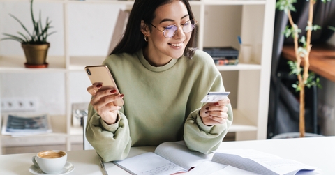 young girl student holding credit card