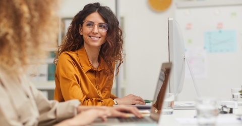 female colleagues interacting while working in office