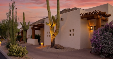 arizona resort under orange sky with cute cactus plant at sunset