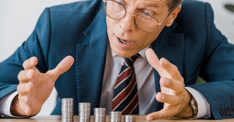 businessman looking at silver coins