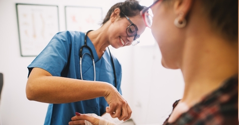 female nurse bandaging at clinic