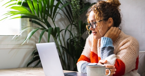 mature woman reading on laptop