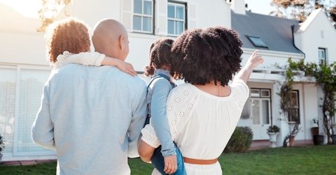 african american family outside new home