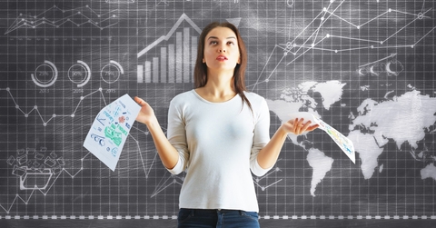 woman besides board with finance charts