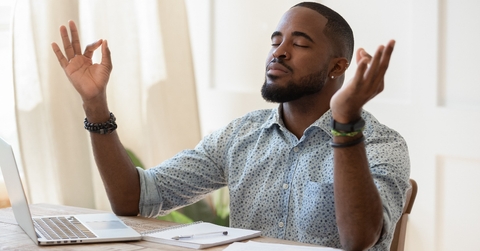 african guy meditating while remote working