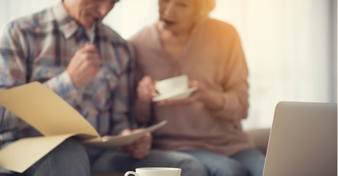 senior couple checking documents at tea