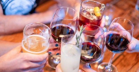 people toasting with drinks at restaurant