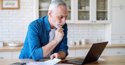mature man looking at laptop