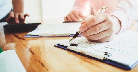 man signing documents at office