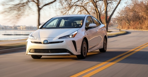 driver driving toyota prius at sunset