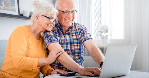 senior couple checking bills