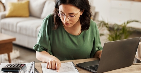 woman preparing budget using laptop