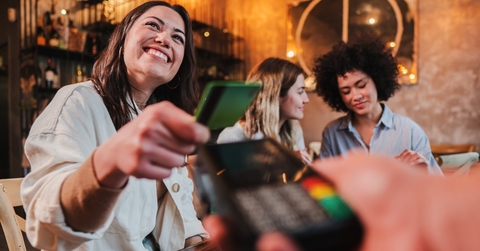 woman paying using card at restaurant