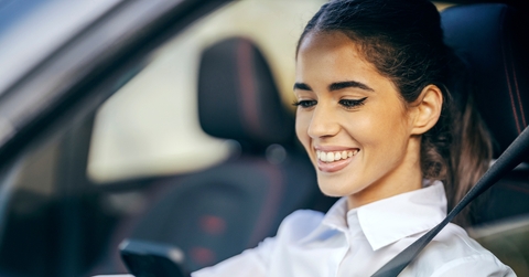 happy woman driving a car