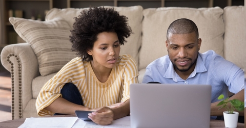 african american family couple calculating expenses