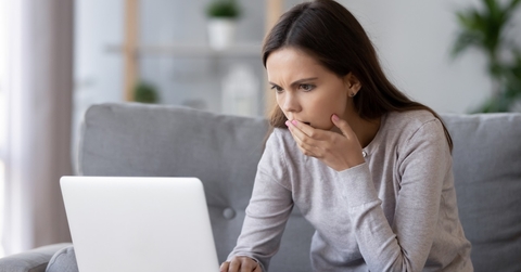 stressed woman reading bad news online