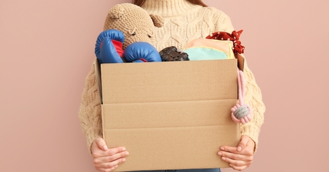 Woman holding box of unwanted stuff