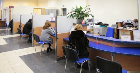 busy bank with people sitting with loan consultants