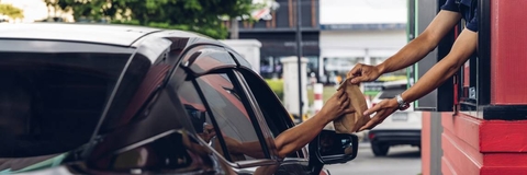 person receiving in fast food drive thru window