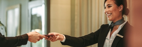 receptionist attending hotel guest