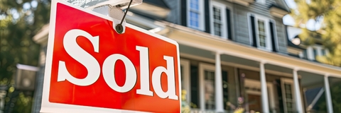 Sold Sign board outside Suburban Home